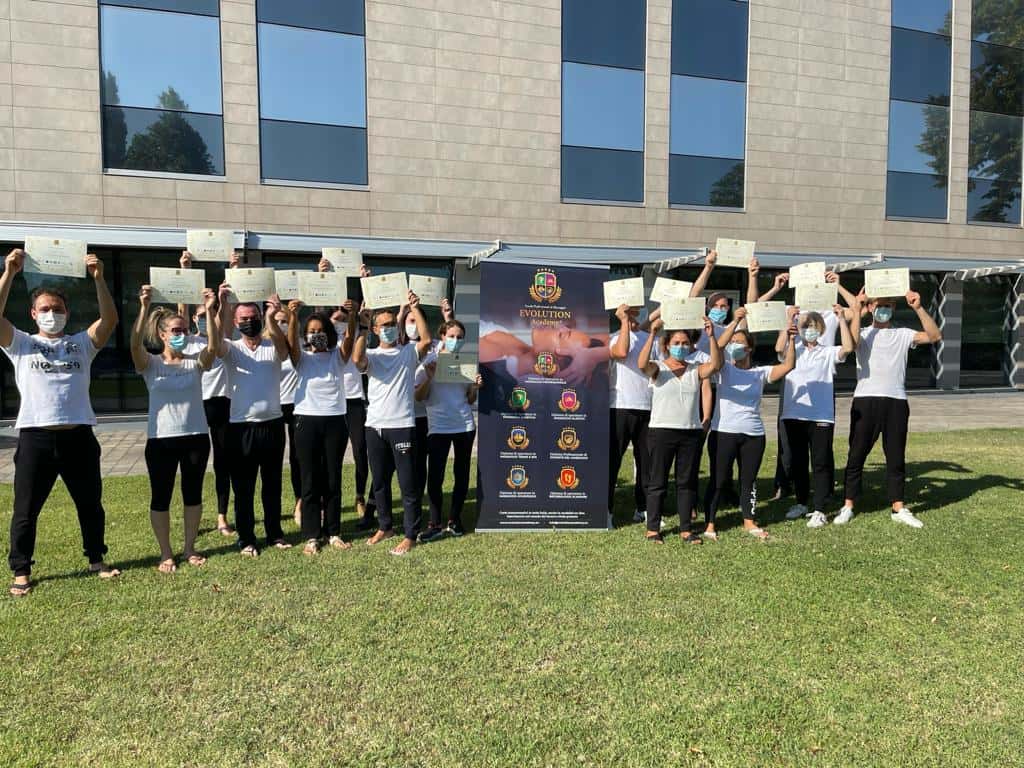 Persone che ricevono certificati di formazione presso Evolution Academy®, ambiente esterno.