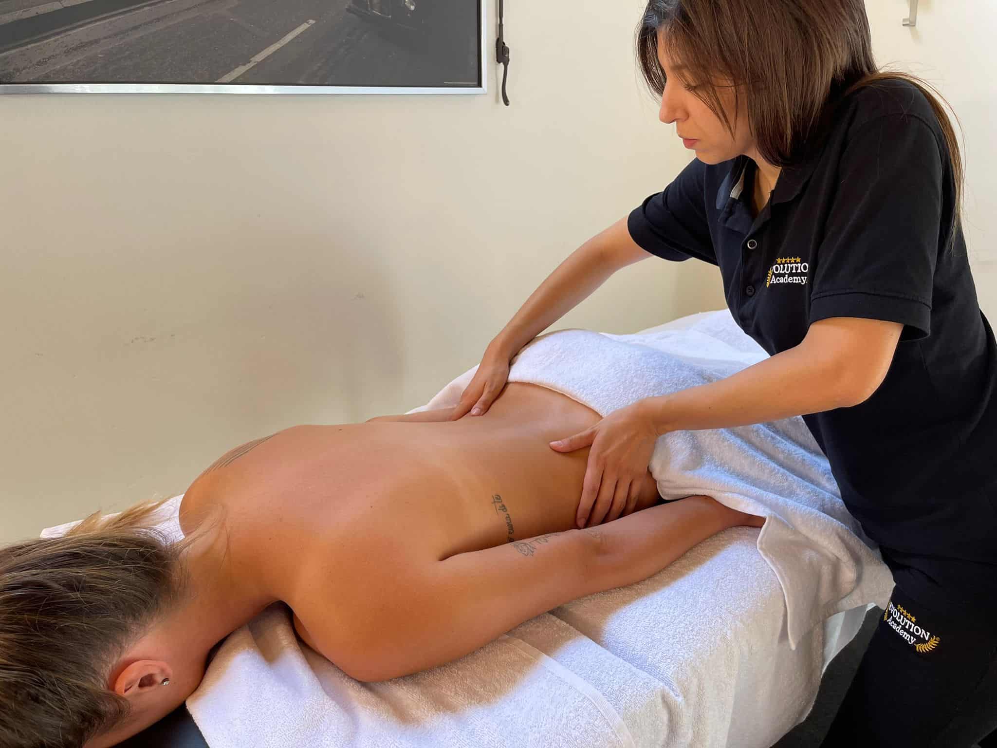 Massaggiatrice professionale durante trattamento di massaggi e terapie benessere corpo Evolution Academy.